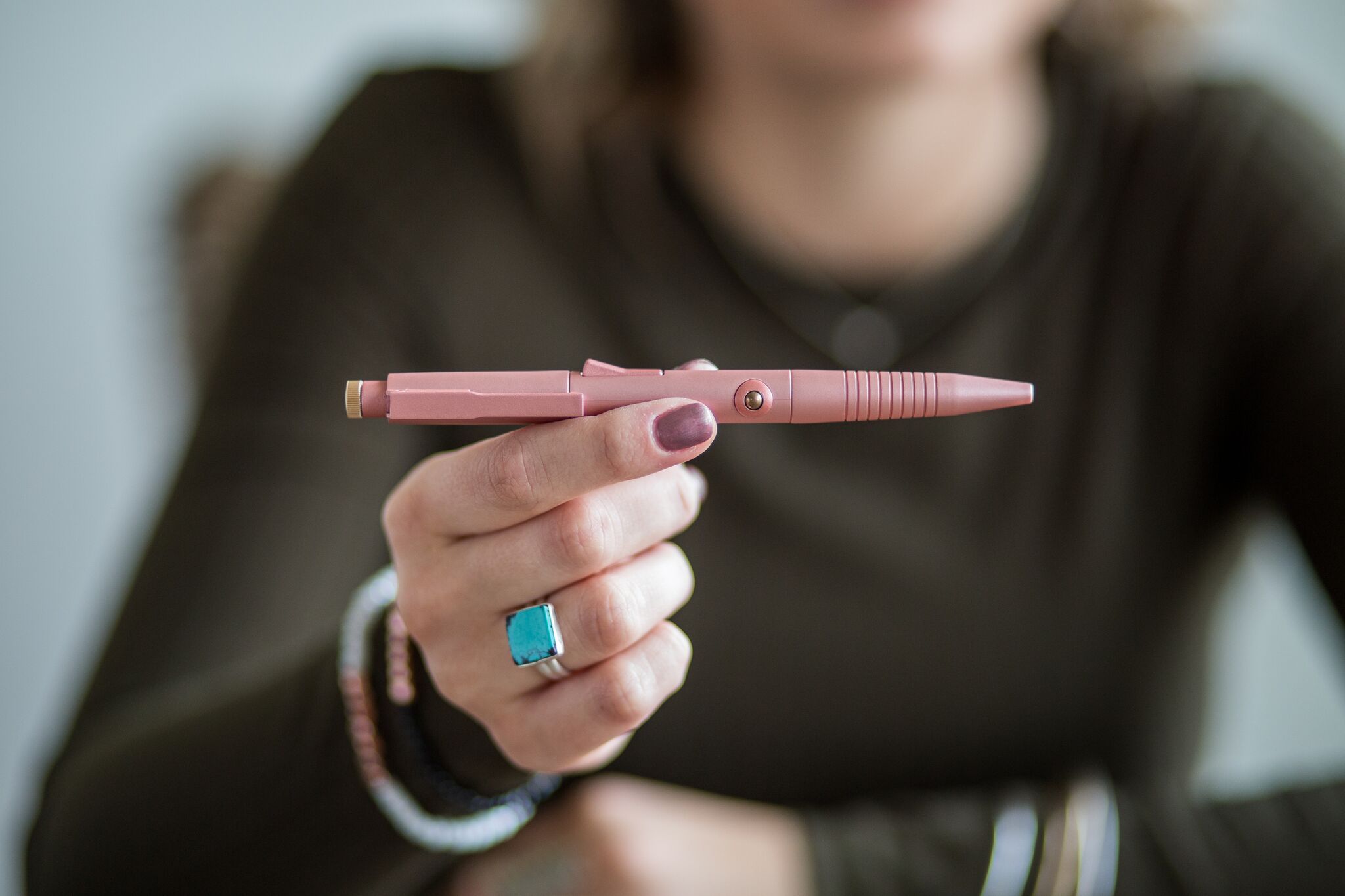 A woman holding the Fidgi Pen productivity product