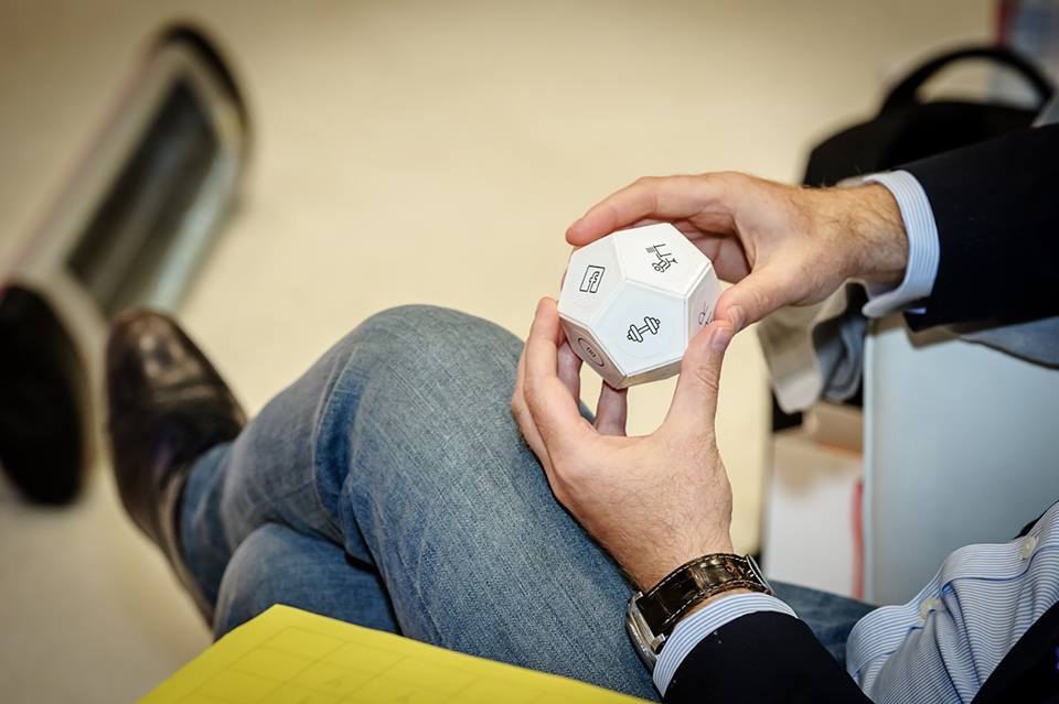 A man holding the TimeFlip productivity gadget