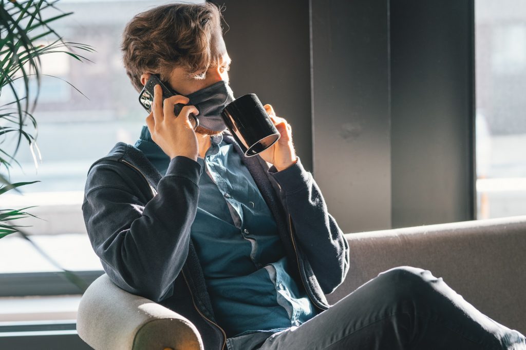 Man talking on a mobile phone with a face mask on