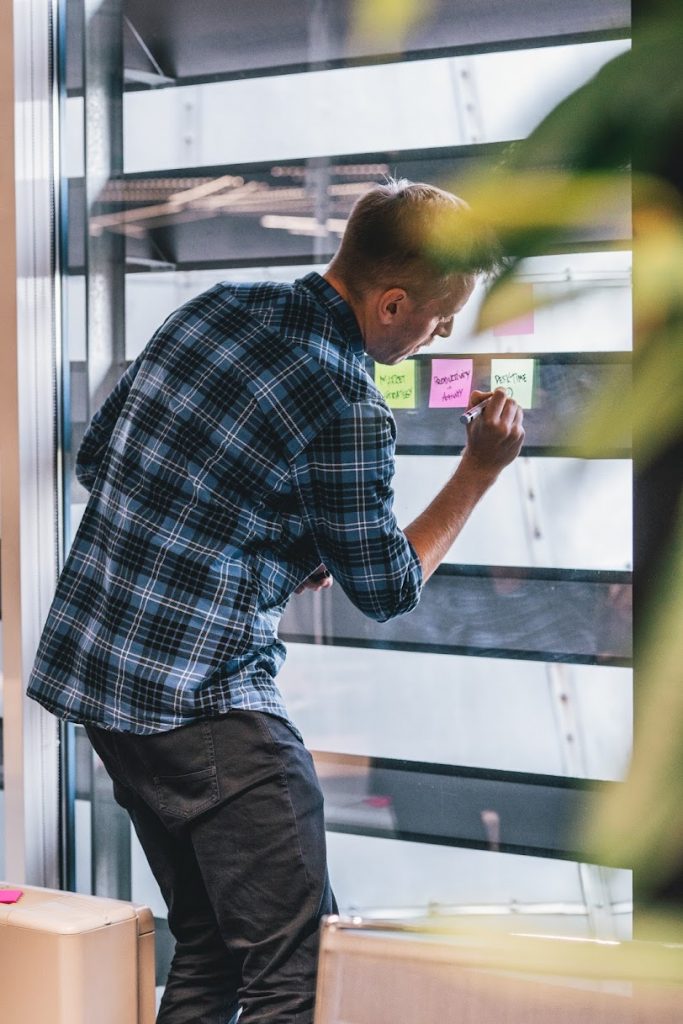 A man writing on post it notes