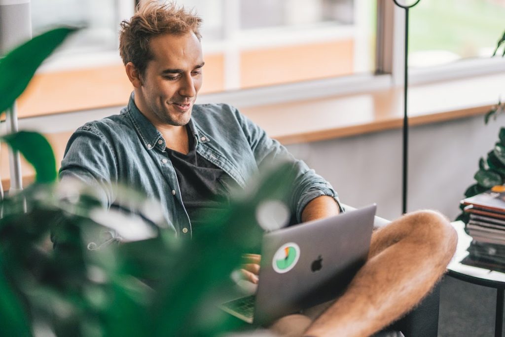 Man using a laptop and smiling