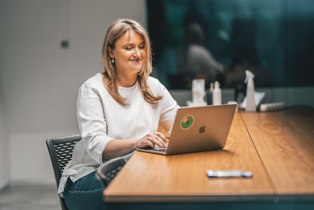 Woman smiling while using laptop