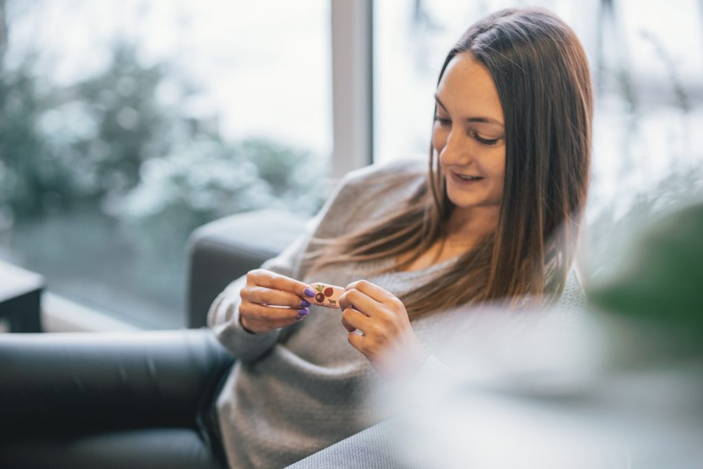 Woman unwrapping a candy