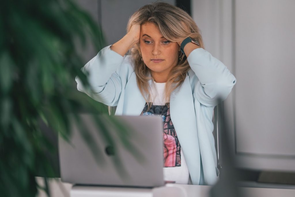 Confused person using a laptop