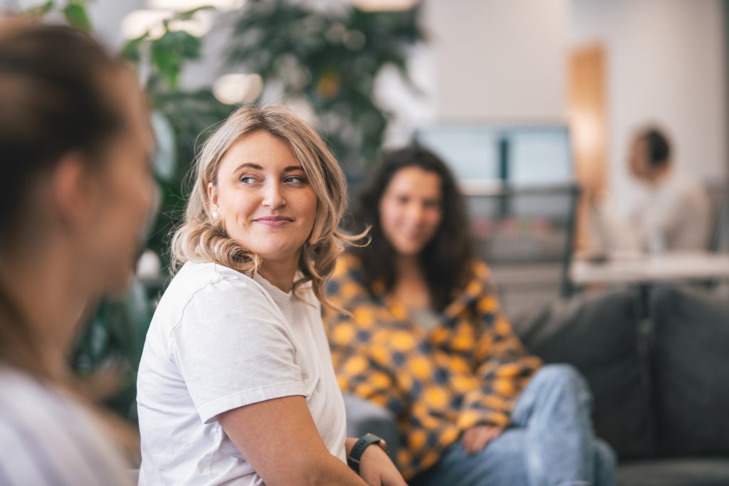 A close-up of an employee in a team meeting