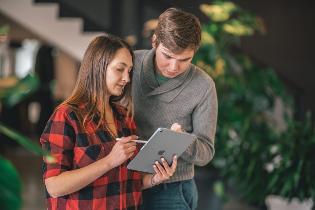 Two coworkers having a conversation on how to build a loyal client base