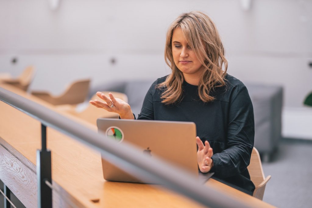 A woman in the workplace working on a laptop