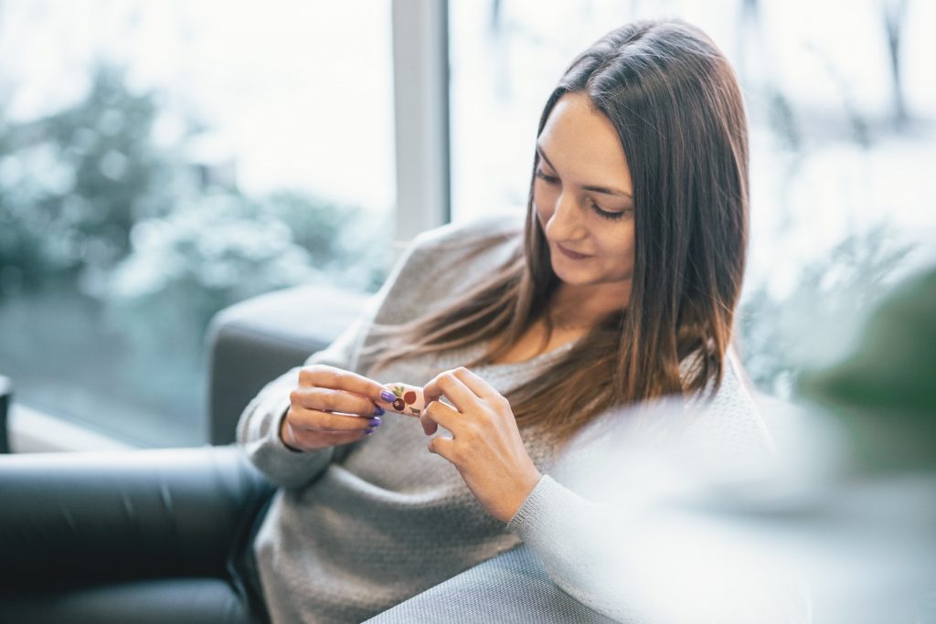 Woman having a candy at the office