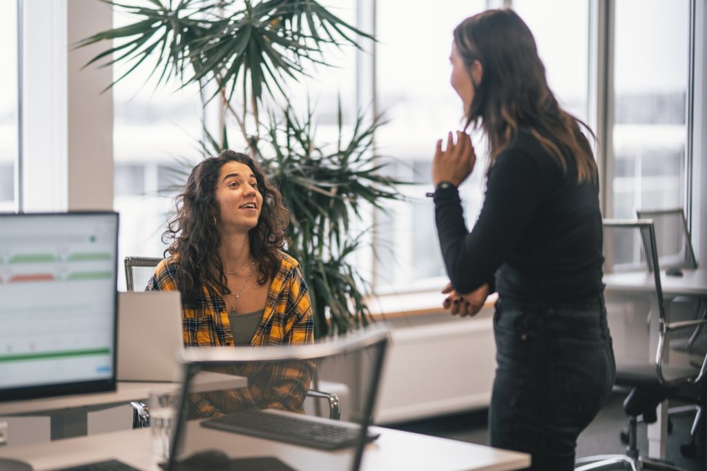 Two colleagues talking in the workplace