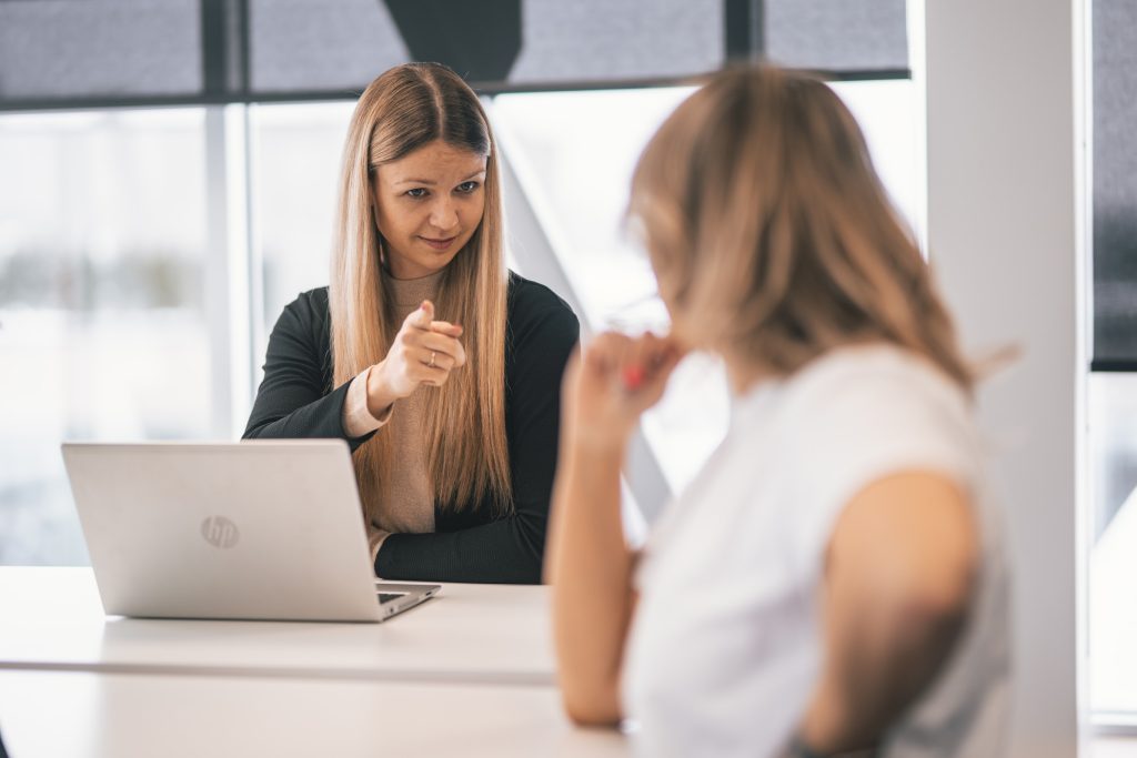 Woman points a finger to her colleague