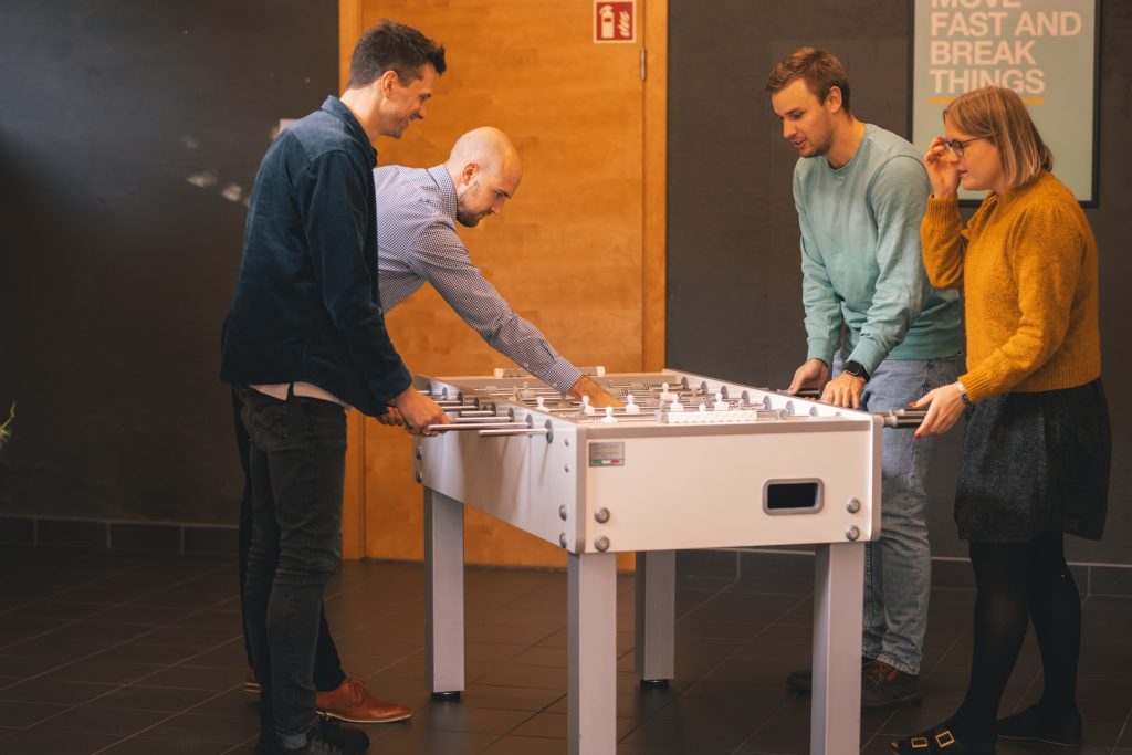 office workers playing foosball
