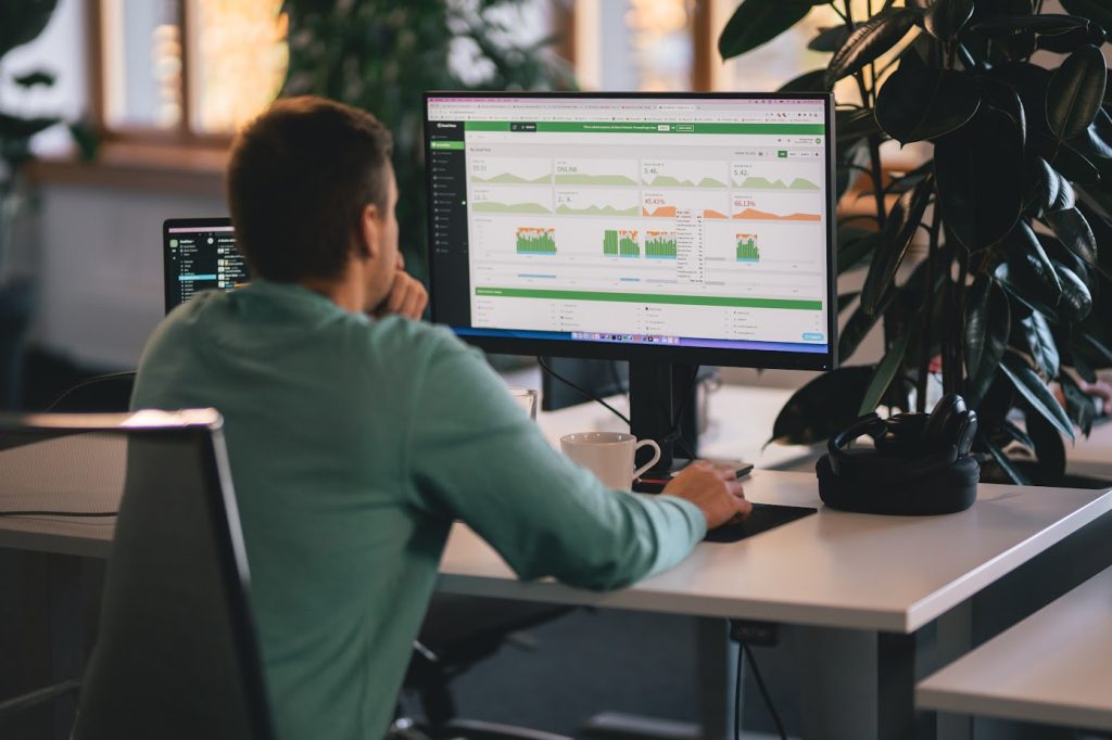 A man checking some stats on a PC