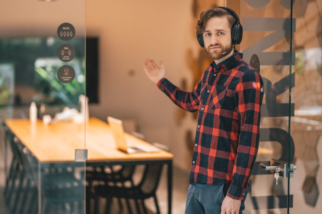 Man inviting people into an empty metaverse workplace