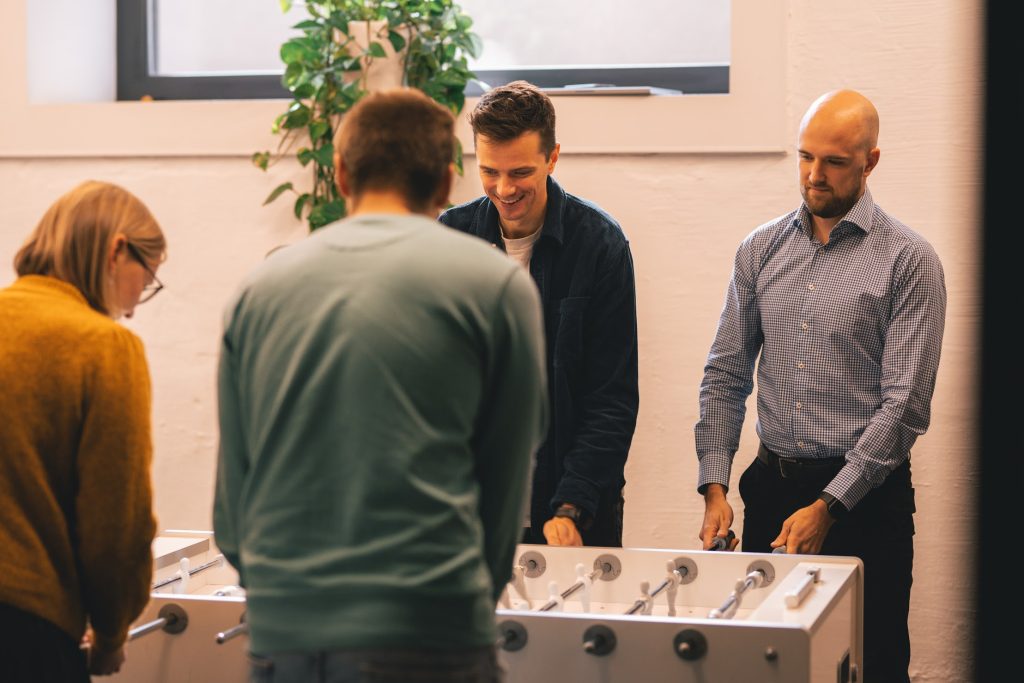 Colleagues playing table football