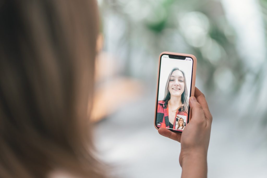 Colleagues talking on video chat via phone