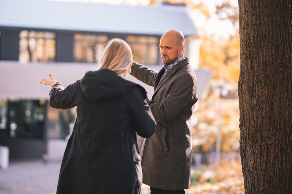 two colleagues talking outside an office building