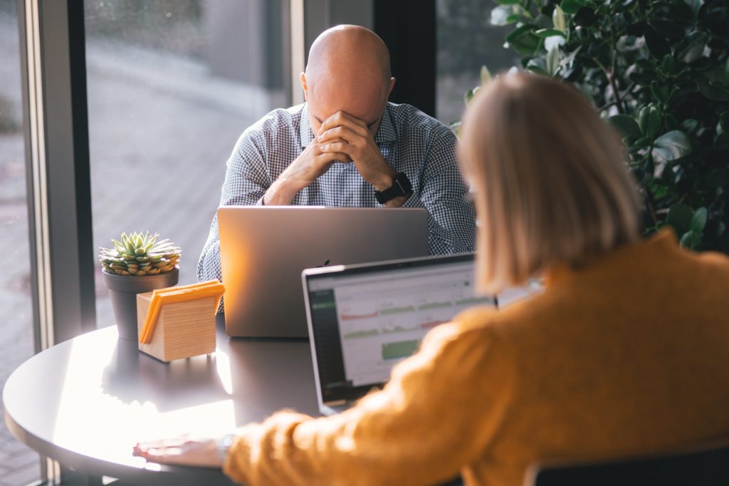 Exhausted worker impacted by toxic positivity at workplace