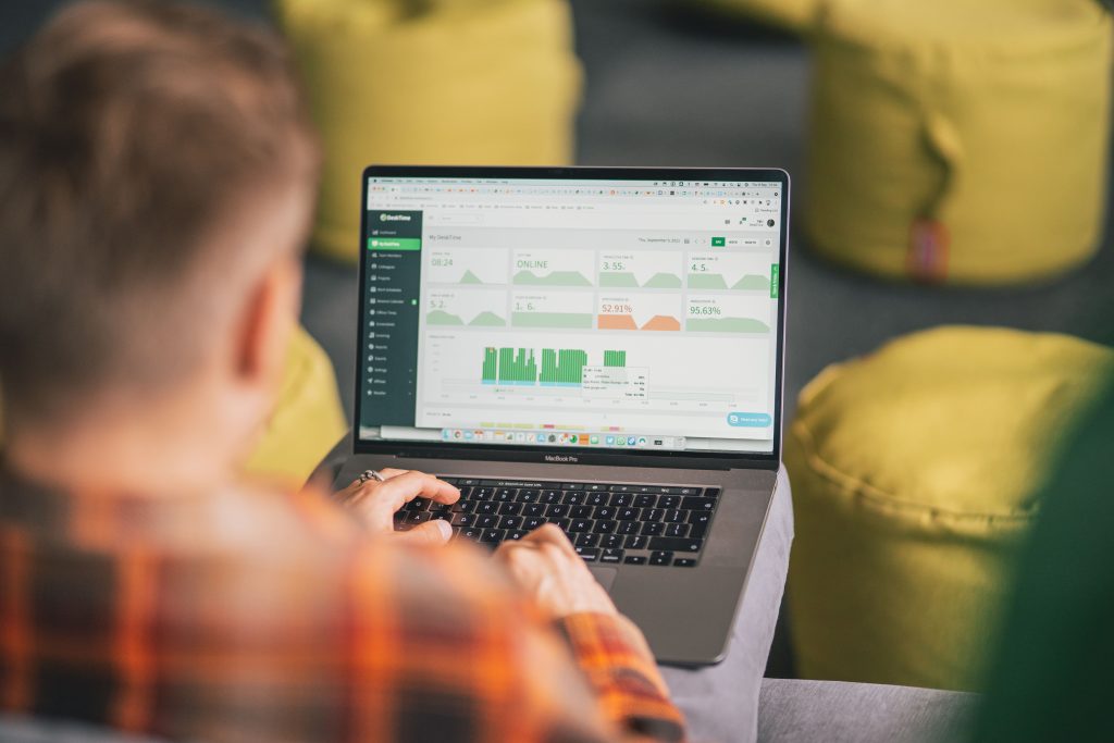 man engaged in project budget tracking on his laptop