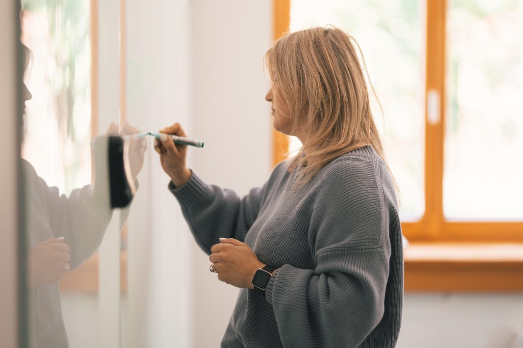 A person writing on a whiteboard