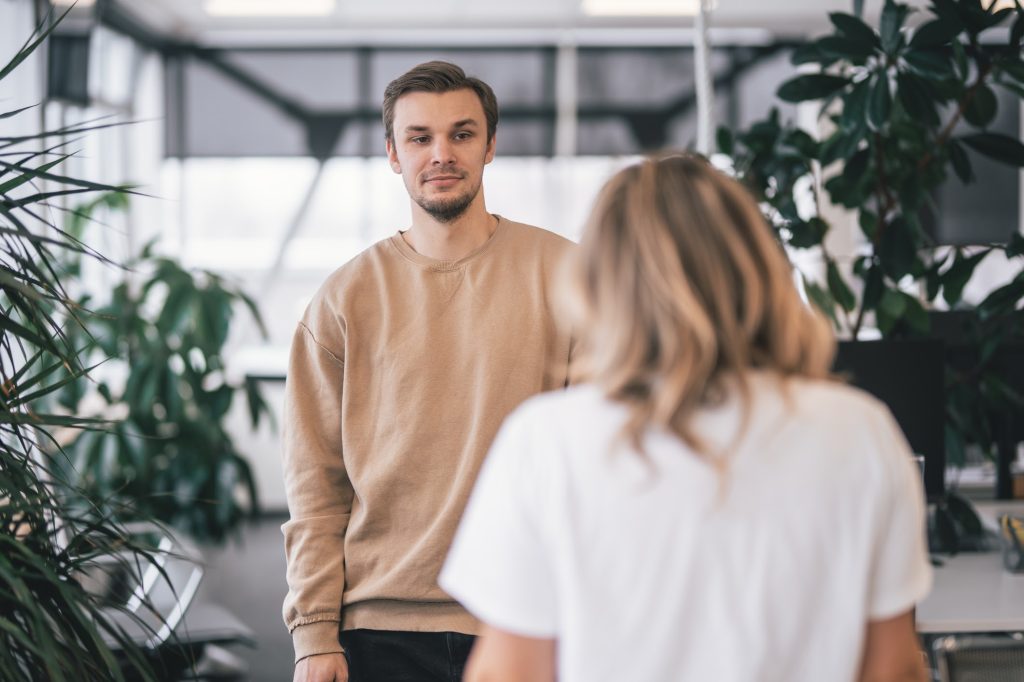 Two people speaking at an office