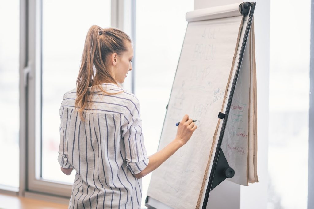A woman at a whiteboard
