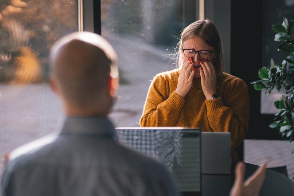 A woman experiencing gaslighting at the workplace