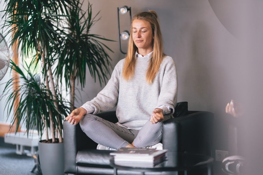 An employee meditating in an office rest area