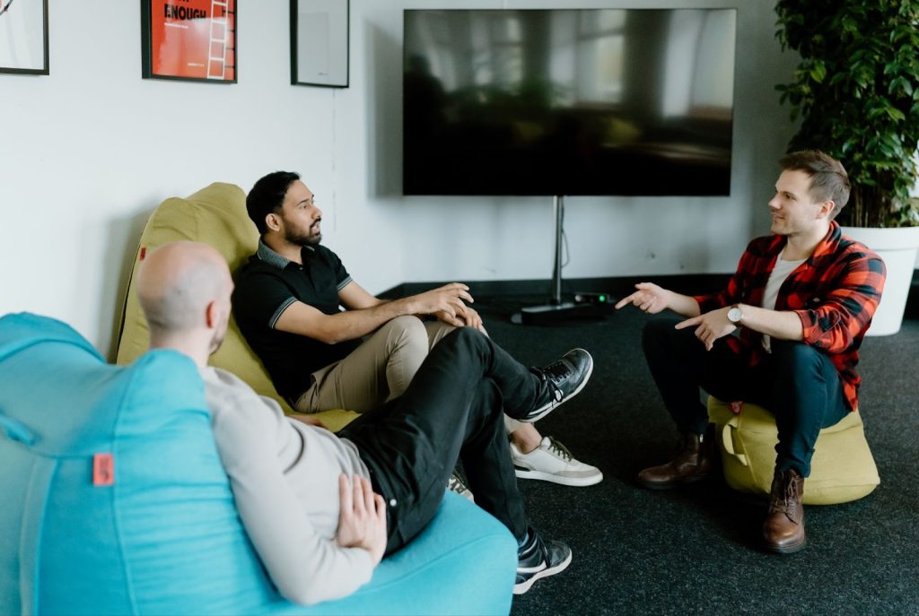 3 men talking about are remote workers more productive