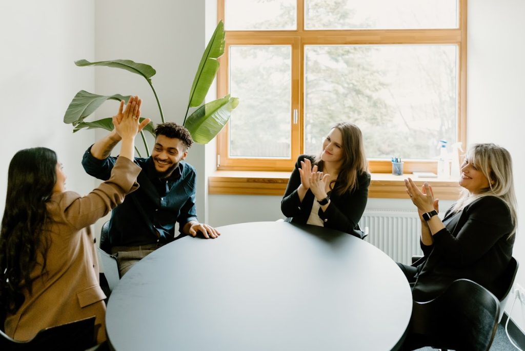 Colleagues high-fiving in the office