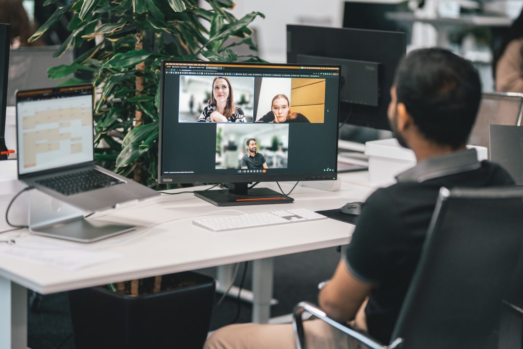 Office worker on a video call with hybrid colleagues