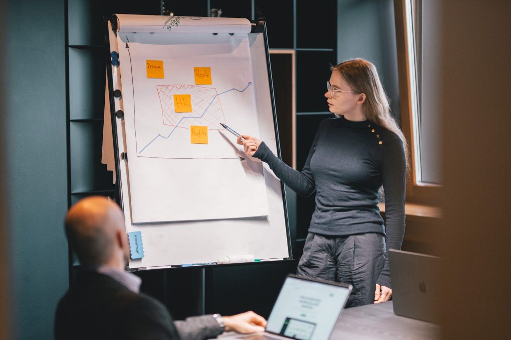 A woman explaining a graph in an office setting