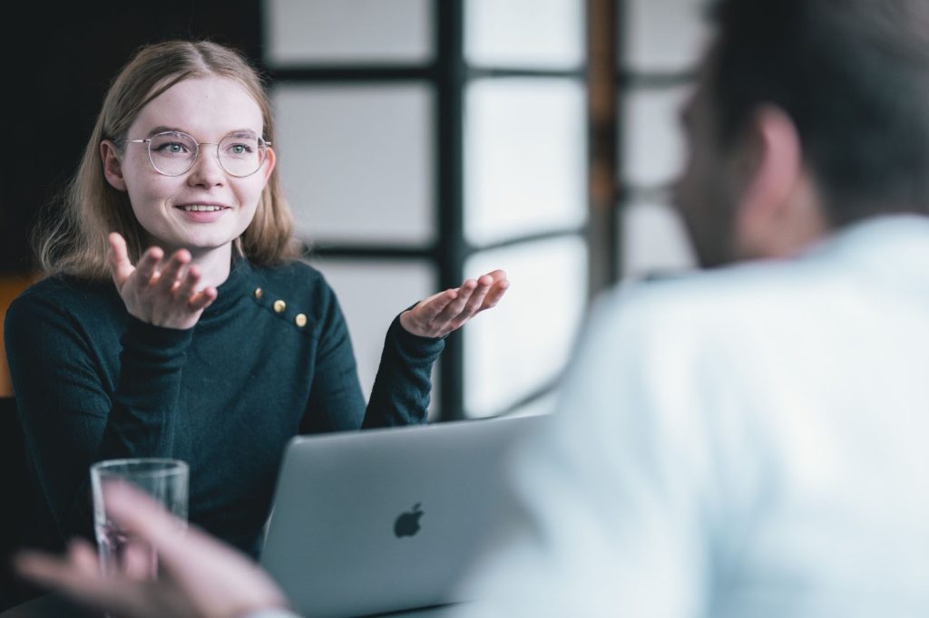Interviewer with laptop questioning potential new hire