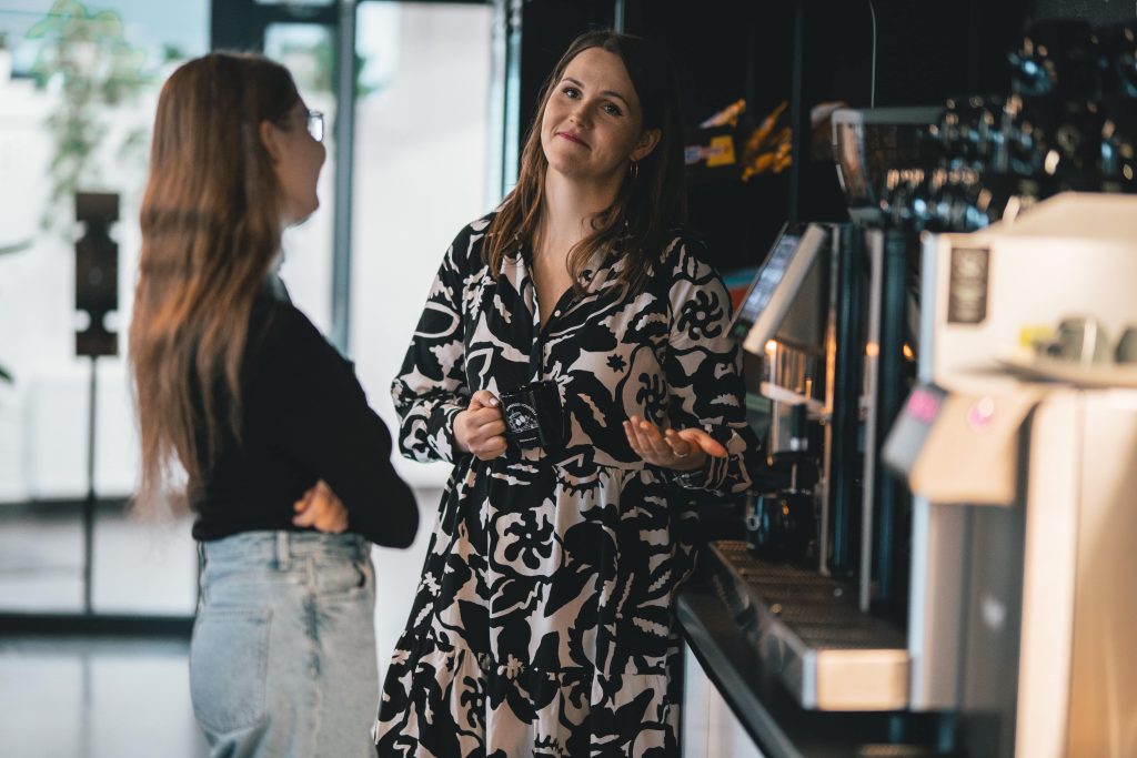 two women coffee badging