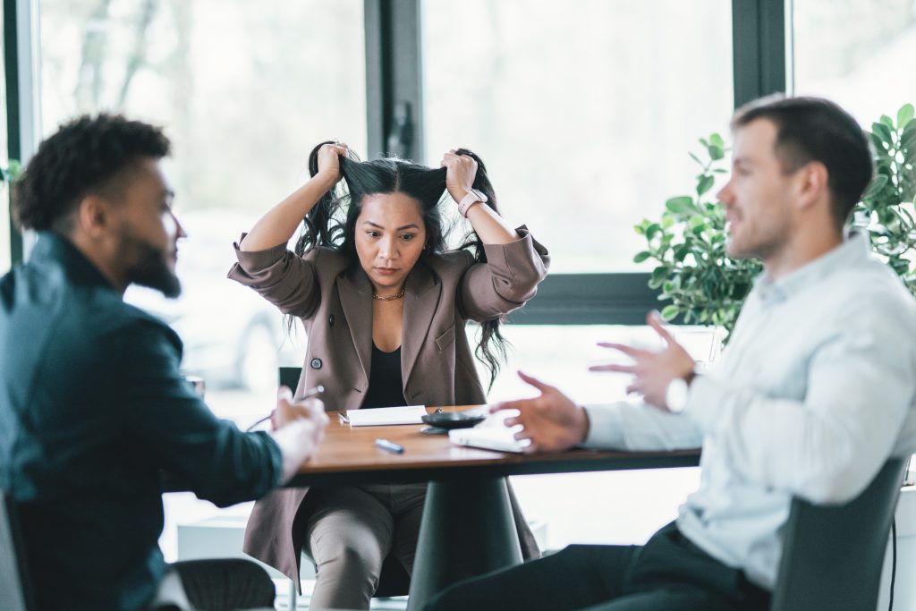 Woman pulling her hair, tired of hearing about AI-powered efficiency