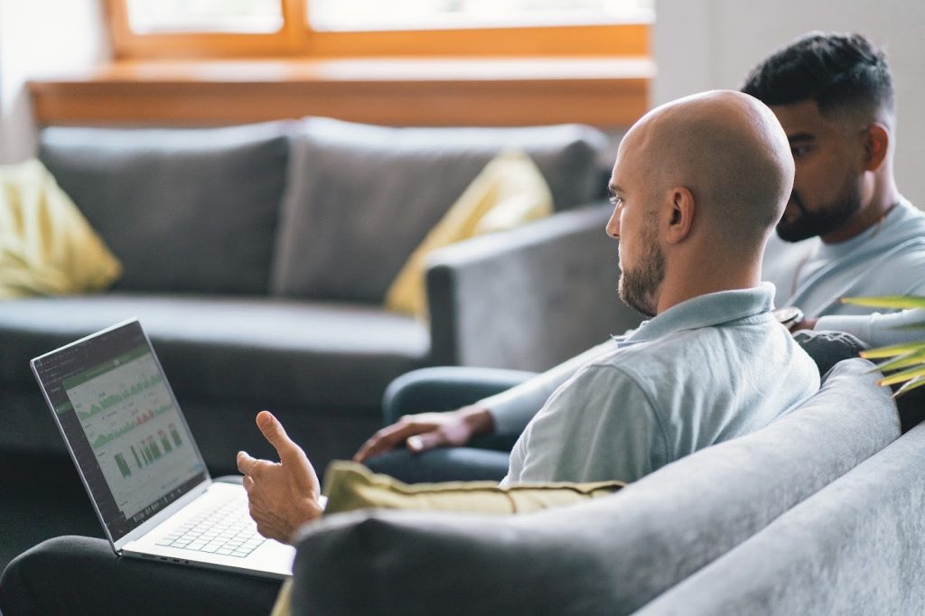 Two men analyzing workforce productivity metrics