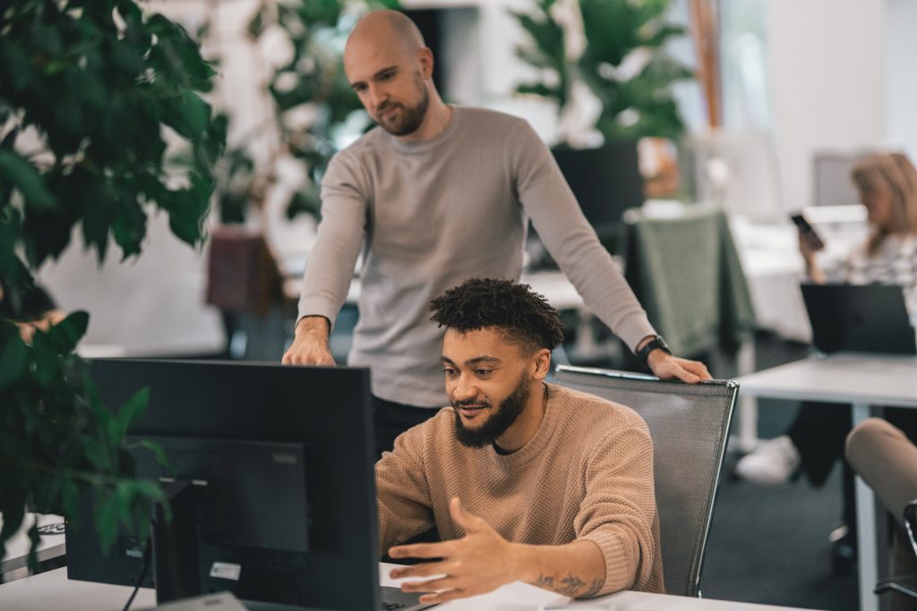 Man pointing out to employee AI workslop effects