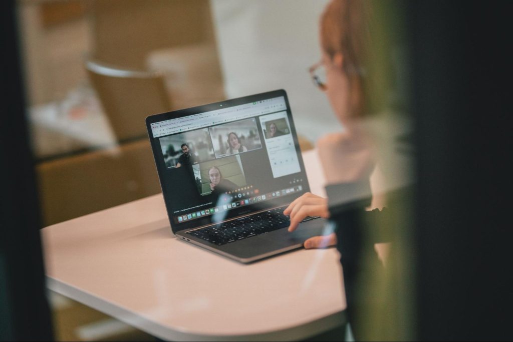 A picture of an ongoing video call on laptop, woman sitting
