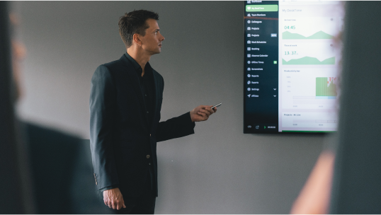 A man presenting data on a screen